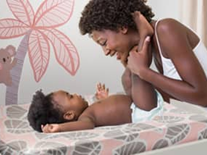 mom and baby on changing pad cover