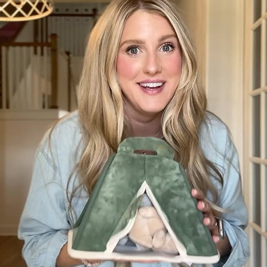 woman holding plush green tent play set