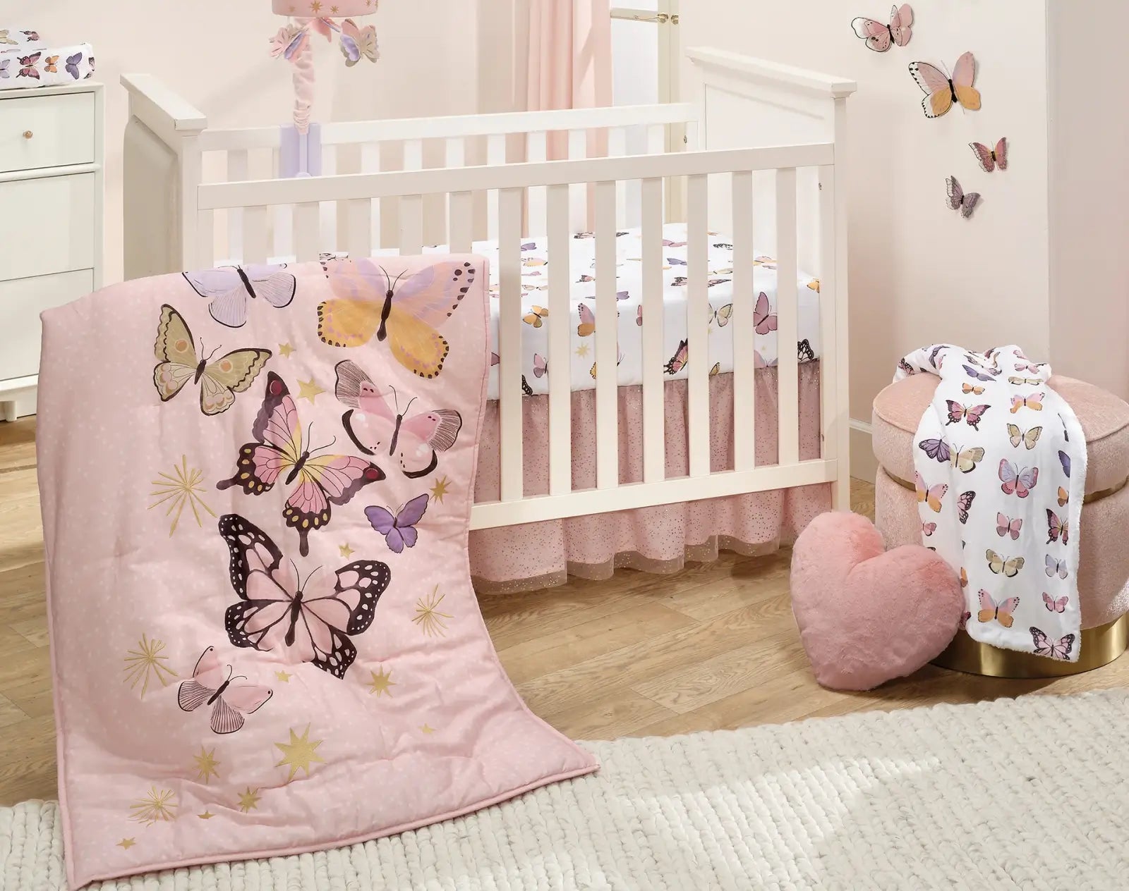 Pink and purple butterfly baby crib bedding set with white crib, matching mobile, window valance, and plush blanket.